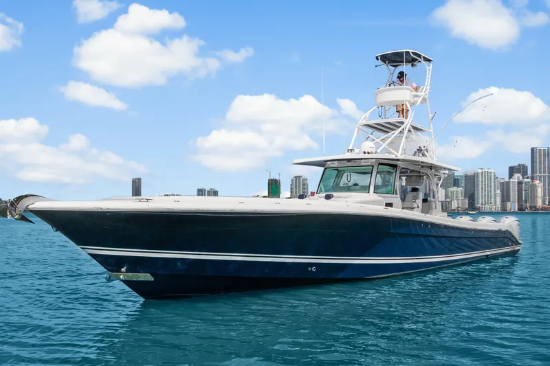 Slide: The Image of 2020 HCB 53 Suenos boat on water with city skyline in background. - 1