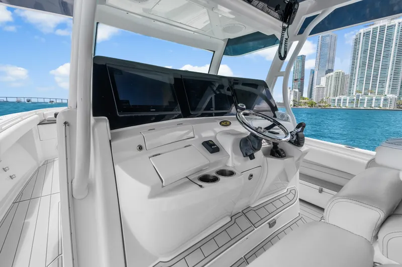 Slide: The Image of 2020 HCB 53 Suenos boat helm with modern controls, city skyline in background. - 39