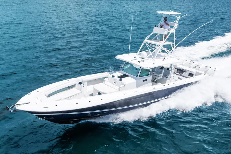 Slide: The Image of 2020 HCB 53 Suenos boat cruising on open water, showcasing sleek design and powerful performance. - 9