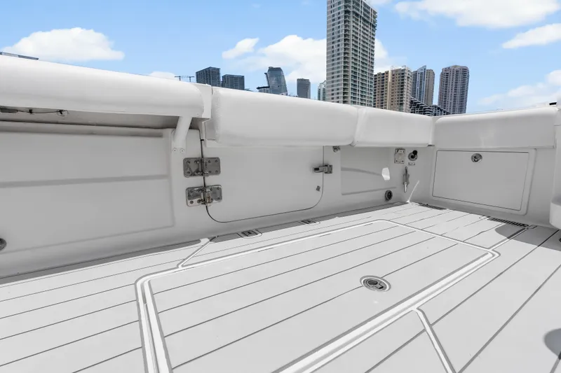 Slide: The Image of Spacious deck of 2020 HCB 53 Suenos boat with city skyline backdrop. - 56