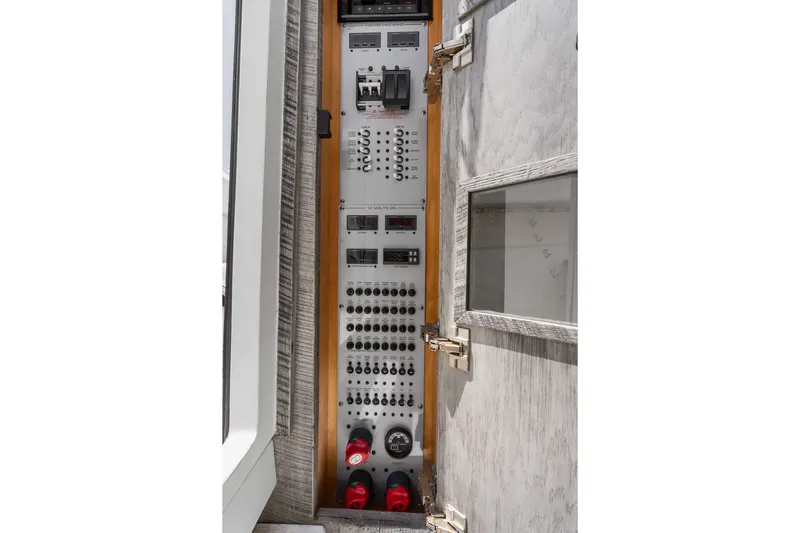 Slide: The Image of Electrical control panel inside 2020 HCB 53 Suenos boat, featuring switches and gauges. - 64