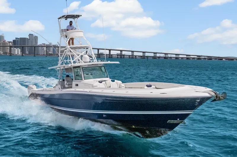 Slide: The Image of 2020 HCB 53 Suenos boat cruising on blue ocean near city skyline. - 15