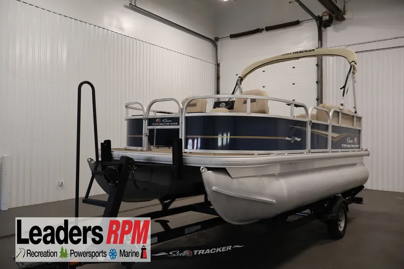 The Image of 2024 Sun Tracker Bass Buggy 16 XL pontoon boat in indoor showroom. - 1