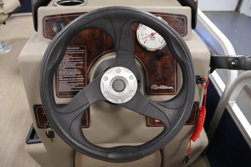 Slide: The Image of 2024 Sun Tracker Bass Buggy 16 XL steering wheel and dashboard close-up. - 22