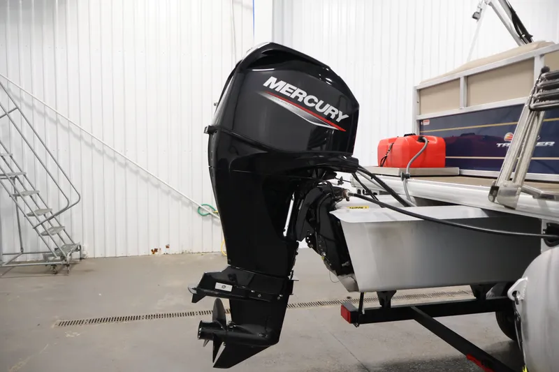 Slide: The Image of 2024 Sun Tracker Bass Buggy 16 XL with Mercury outboard motor in a garage setting. - 31