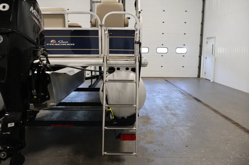 Slide: The Image of 2024 Sun Tracker Bass Buggy 16 XL pontoon boat with ladder in a garage. - 30