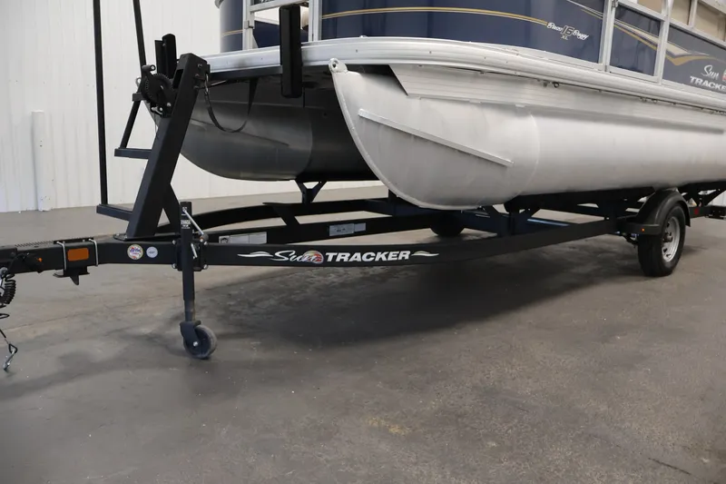 Slide: The Image of 2024 Sun Tracker Bass Buggy 16 XL pontoon boat on trailer in a showroom. - 36