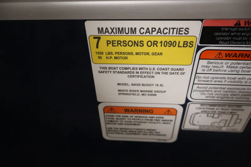 Slide: The Image of 2024 Sun Tracker Bass Buggy 16 XL capacity label, 7 persons or 1090 lbs, safety warnings. - 24