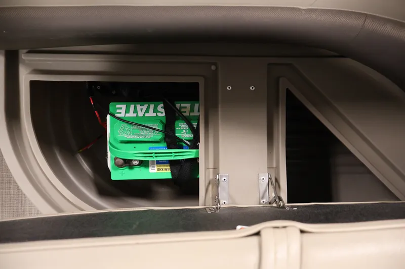 Slide: The Image of 2024 Sun Tracker Bass Buggy 16 XL battery compartment with green Interstate battery. - 28