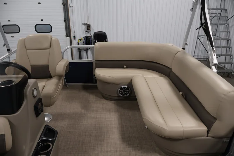 Slide: The Image of 2024 Sun Tracker Bass Buggy 16 XL interior with beige seating and steering console. - 26