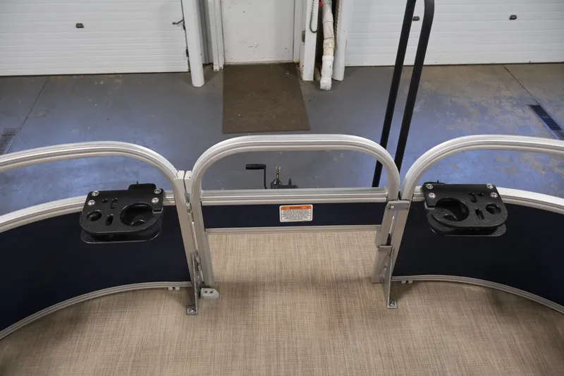 Slide: The Image of 2024 Sun Tracker Bass Buggy 16 XL pontoon boat with rod holders and safety railing. - 15