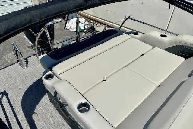 Slide: The Image of 2026 Barletta Cabrio 24U boat with spacious beige seating and cup holders. - 14