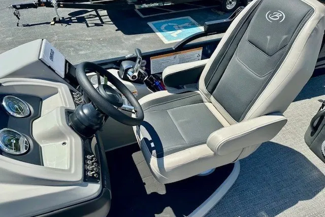 Slide: The Image of Captain's seat and helm of 2026 Barletta Cabrio 24U pontoon boat, featuring modern controls. - 7