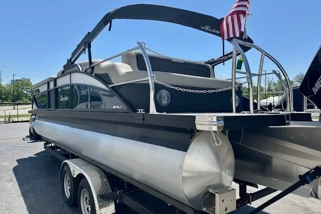 Slide: The Image of 2026 Barletta Cabrio 24U pontoon boat on trailer, featuring sleek design and American flag. - 6