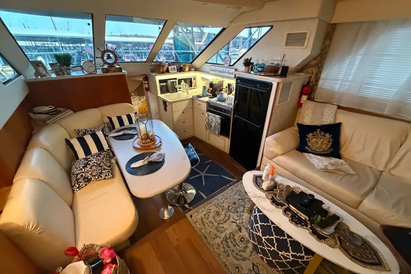 Slide: The Image of Interior of 1998 Silverton 352 Motor Yacht with cozy seating and elegant decor. - 28
