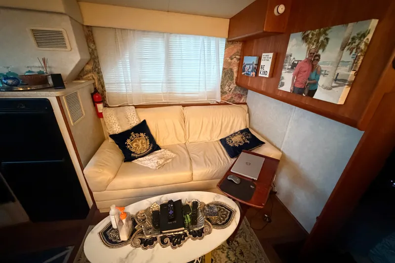 Slide: The Image of Interior of 1998 Silverton 352 Motor Yacht with cozy seating and decor. - 10