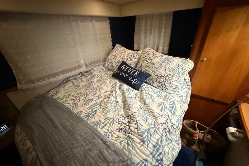 Slide: The Image of Cozy bedroom in 1998 Silverton 352 Motor Yacht with nautical-themed bedding. - 21
