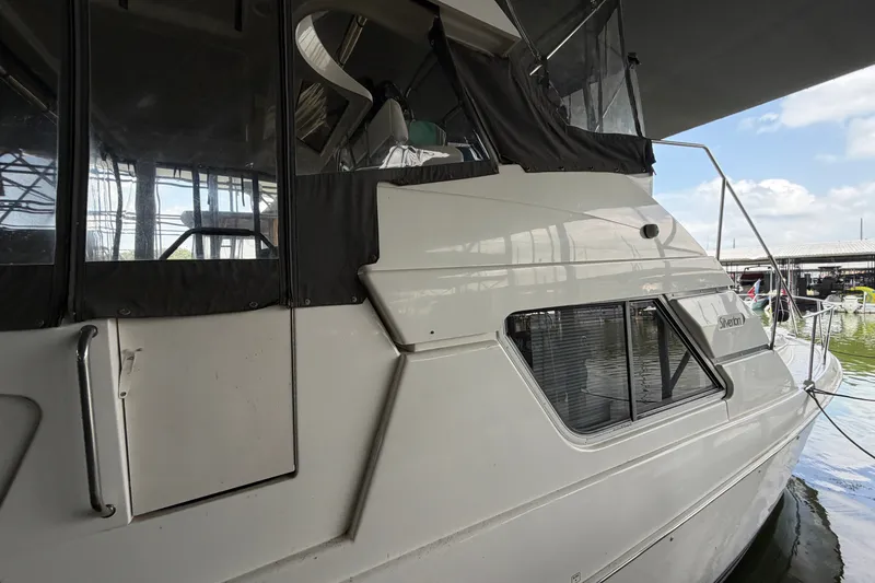 Slide: The Image of 1998 Silverton 352 Motor Yacht docked under a covered marina. - 6