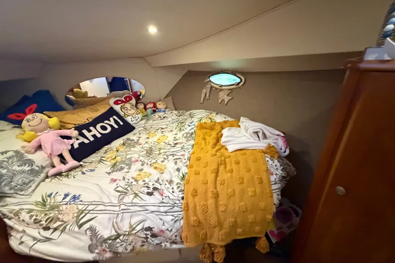 Slide: The Image of Cozy cabin interior of 1998 Silverton 352 Motor Yacht with plush bedding and decorative pillows. - 16