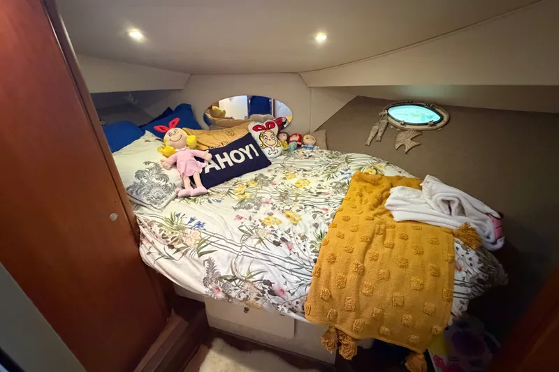 Slide: The Image of Cozy bedroom in 1998 Silverton 352 Motor Yacht with floral bedding and plush toys. - 15