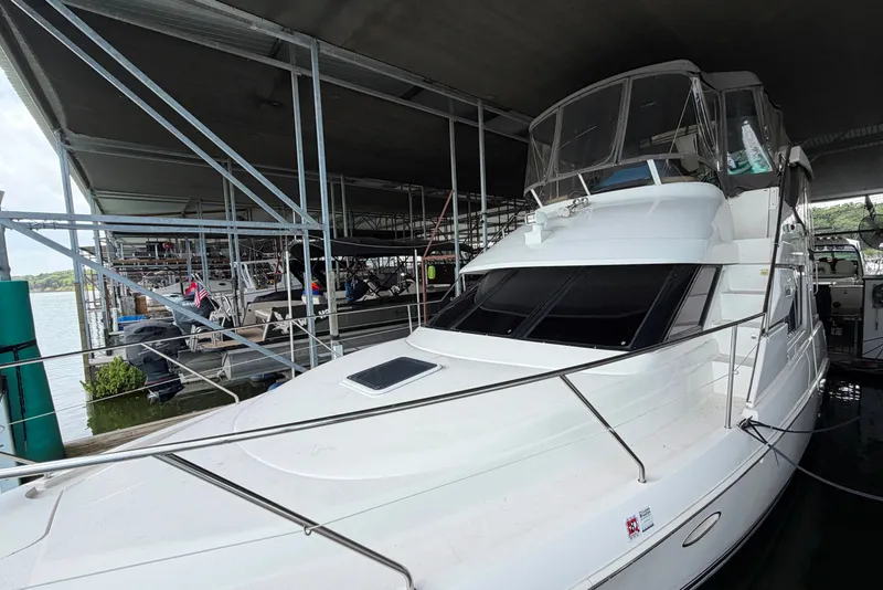 Slide: The Image of 1998 Silverton 352 Motor Yacht docked under a covered marina. - 1