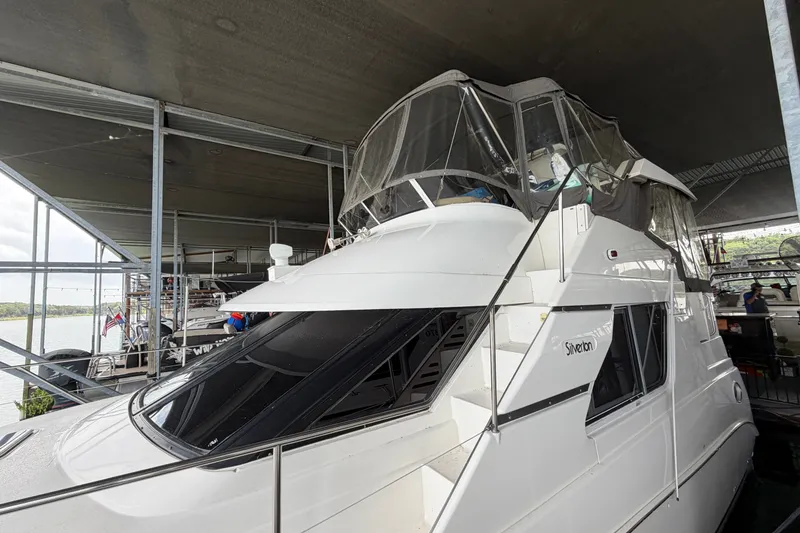 Slide: The Image of 1998 Silverton 352 Motor Yacht docked under a covered marina. - 2
