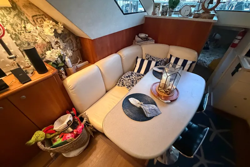Slide: The Image of Interior of 1998 Silverton 352 Motor Yacht with cozy seating and nautical decor. - 12