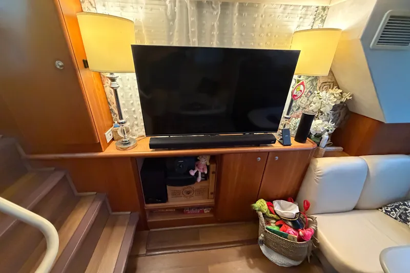 Slide: The Image of Interior of 1998 Silverton 352 Motor Yacht with TV, lamps, and cozy seating area. - 11