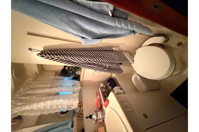 Slide: The Image of Bathroom interior of 1998 Silverton 352 Motor Yacht with towels and toilet. - 24