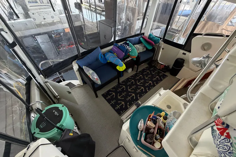 Slide: The Image of Interior of a 1998 Silverton 352 Motor Yacht with cozy seating and nautical decor. - 29