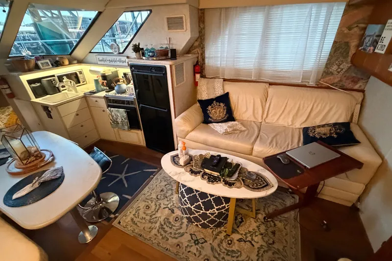 Slide: The Image of Interior of a 1998 Silverton 352 Motor Yacht with cozy seating and kitchenette. - 27
