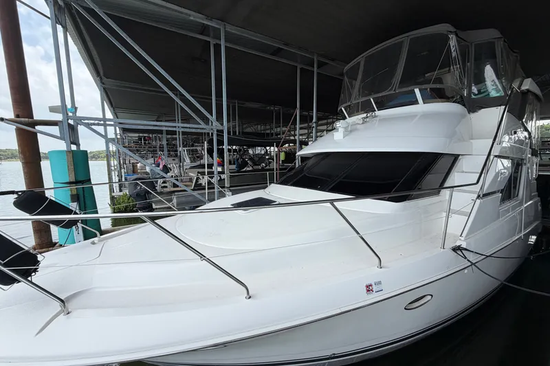Slide: The Image of 1998 Silverton 352 Motor Yacht docked under a covered marina. - 0