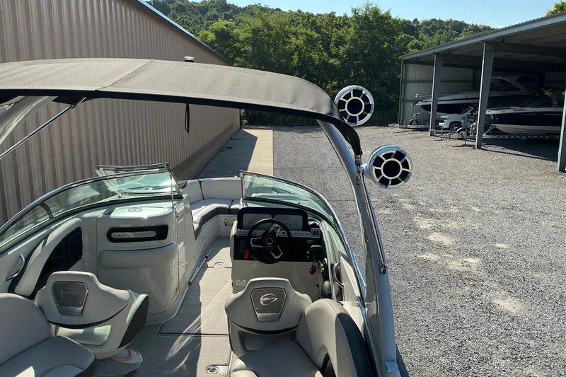 Slide: The Image of 2022 Crownline 290 SS boat interior with sleek seating and modern dashboard. - 14