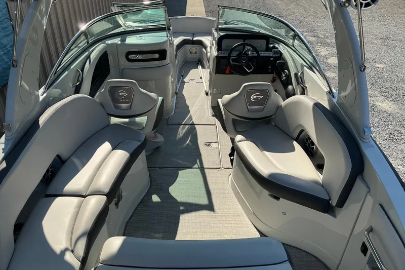 Slide: The Image of 2022 Crownline 290 SS boat interior with sleek seating and modern dashboard. - 13