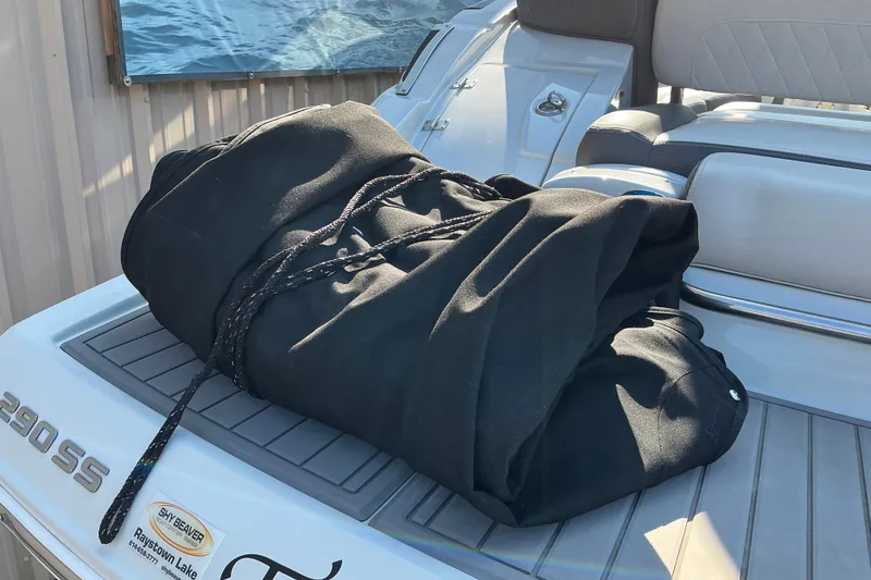 Slide: The Image of 2022 Crownline 290 SS boat with black cover on deck. - 12