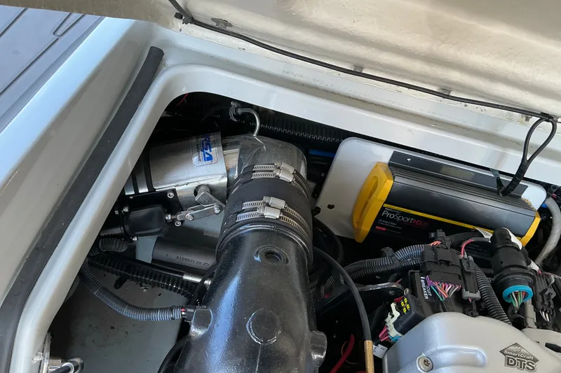Slide: The Image of Engine compartment of 2022 Crownline 290 SS boat, featuring ProSport HD20 charger. - 17