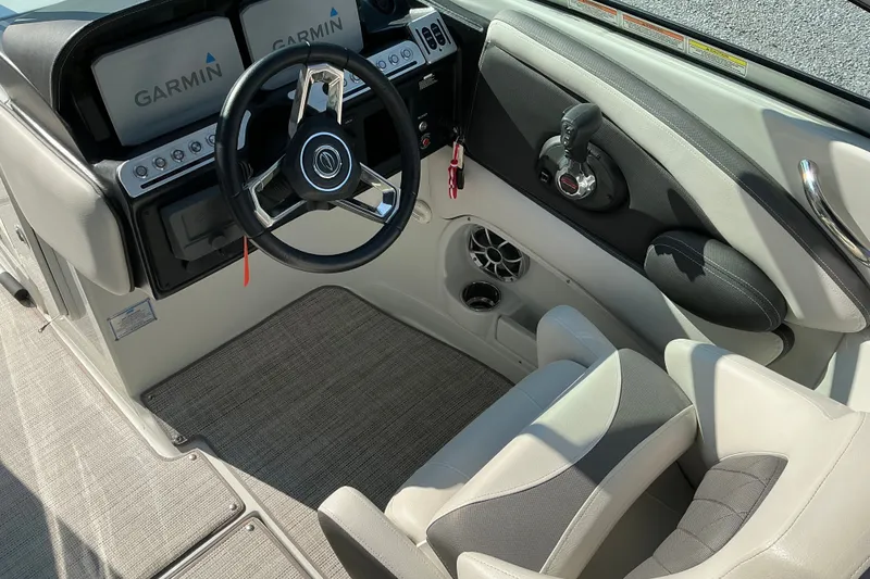 Slide: The Image of 2022 Crownline 290 SS boat cockpit with Garmin displays and steering wheel. - 19