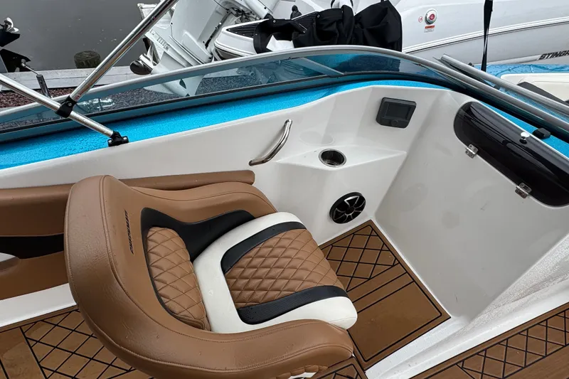 Slide: The Image of 2021 Checkmate Pulsare 2400 BRX boat interior with brown seating and modern design. - 20