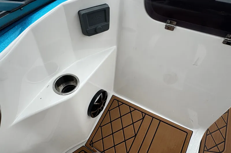 Slide: The Image of Interior of 2021 Checkmate Pulsare 2400 BRX boat with cup holder and speaker. - 21