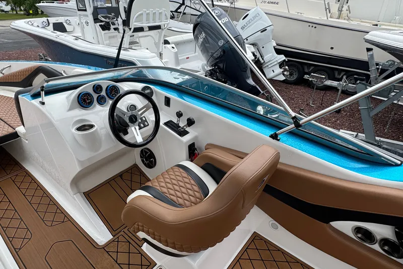 Slide: The Image of Interior of 2021 Checkmate Pulsare 2400 BRX boat with modern dashboard and seating. - 10