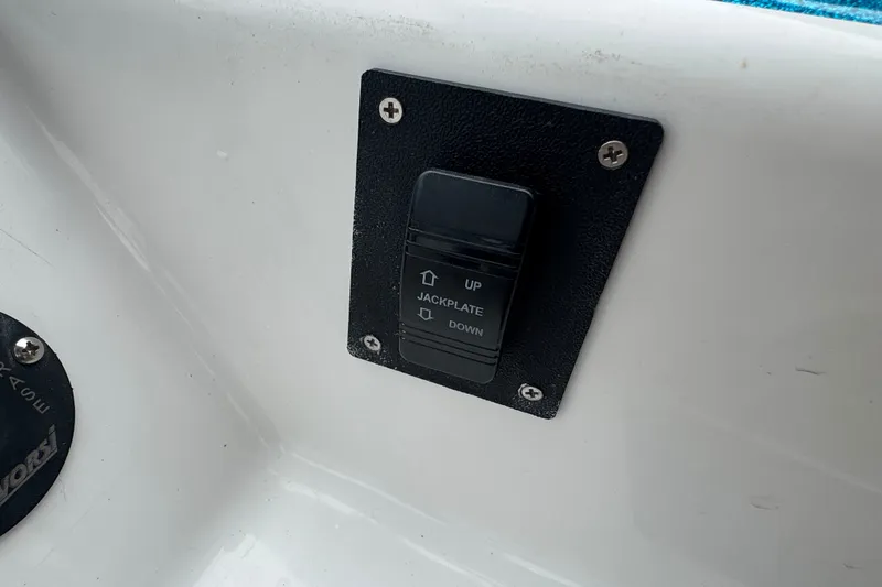 Slide: The Image of Jackplate control switch on 2021 Checkmate Pulsare 2400 BRX boat dashboard. - 17