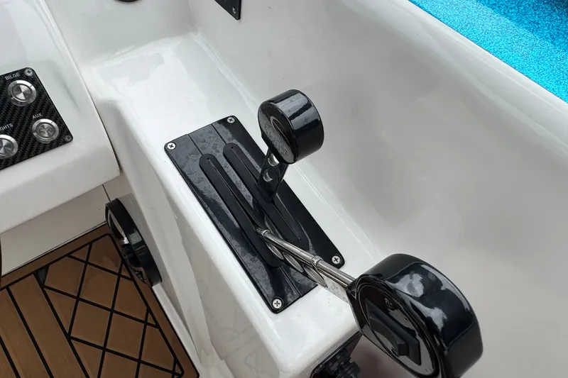 Slide: The Image of Throttle controls on a 2021 Checkmate Pulsare 2400 BRX boat, featuring sleek design and functionality. - 16