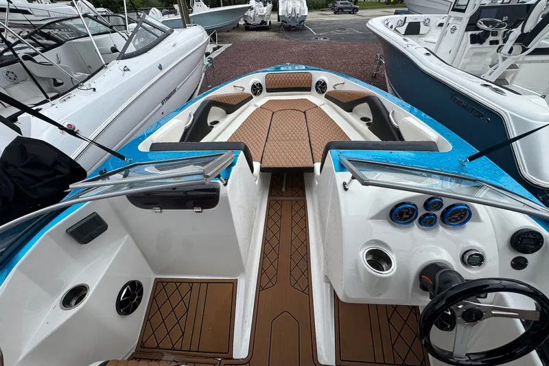 Slide: The Image of 2021 Checkmate Pulsare 2400 BRX boat interior with modern dashboard and seating. - 22