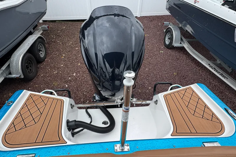 Slide: The Image of 2021 Checkmate Pulsare 2400 BRX boat with sleek motor and stylish deck design. - 8