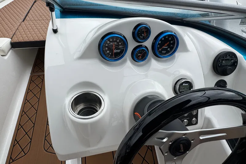 Slide: The Image of Dashboard of 2021 Checkmate Pulsare 2400 BRX boat with gauges and steering wheel. - 19