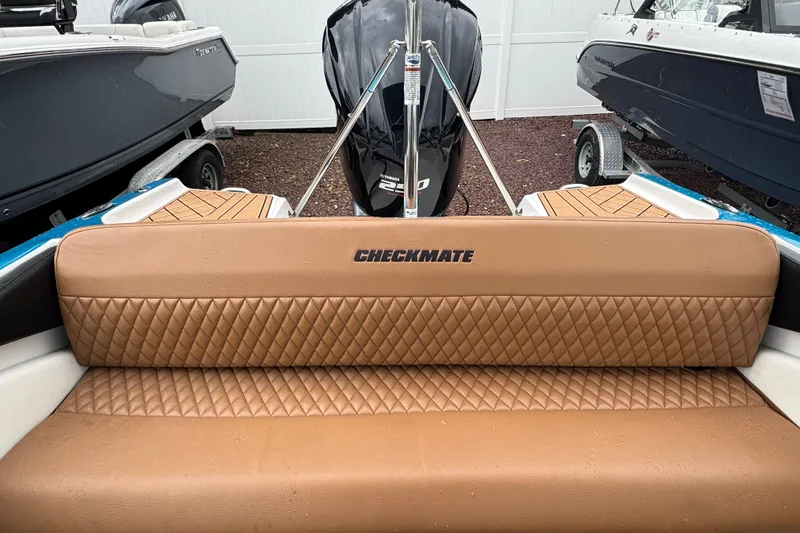 Slide: The Image of 2021 Checkmate Pulsare 2400 BRX boat with tan quilted seating and Yamaha engine. - 9