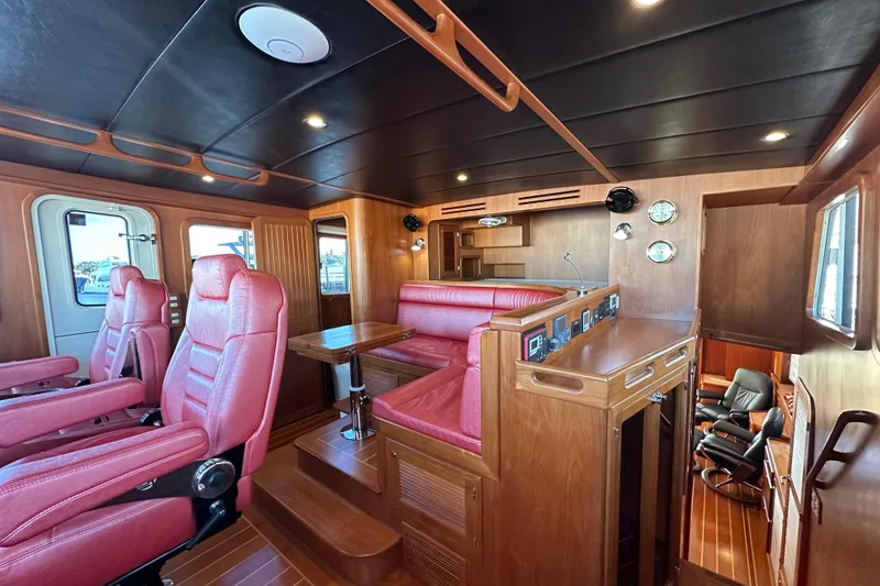 Slide: The Image of Luxurious 2017 Kadey-Krogen 58EB yacht interior with red leather seating and wooden finishes. - 25