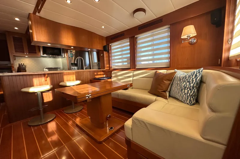 Slide: The Image of Luxurious 2017 Kadey-Krogen 58EB yacht interior with elegant wood finishes and cozy seating area. - 9