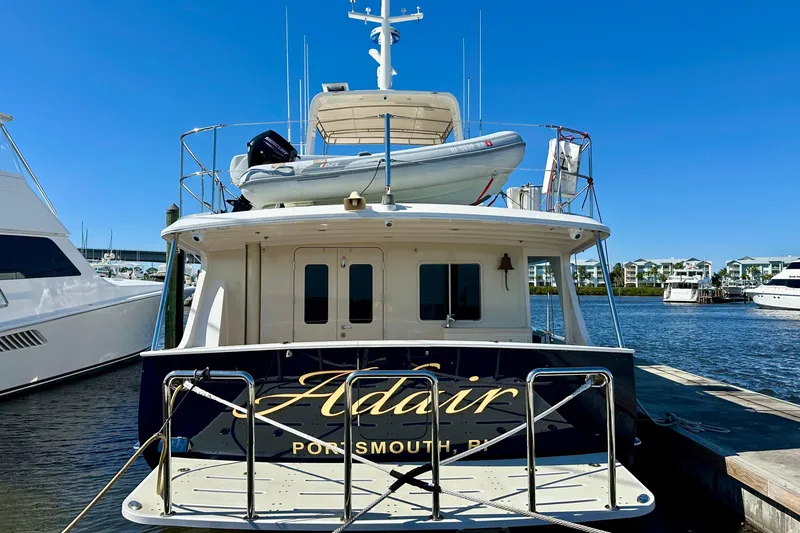 Slide: The Image of Kadey-Krogen 58EB 2017 yacht docked, featuring a small boat on top, clear blue sky. - 87