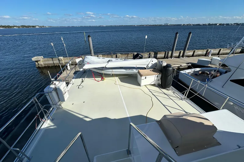 Slide: The Image of 2017 Kadey-Krogen 58EB yacht deck with tender, docked by the waterfront. - 78
